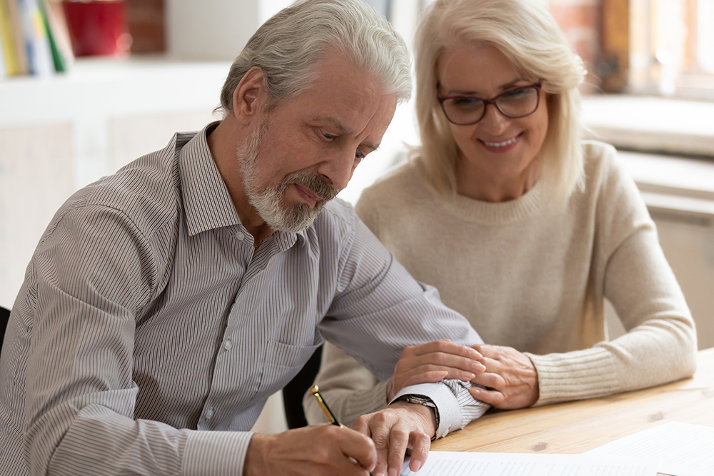 Happy Older Couple Figuring Out Their Social Security Funding Plan